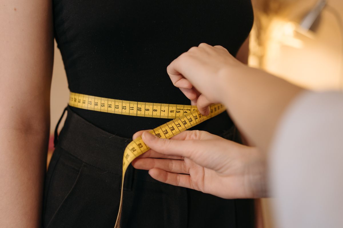 Measuring tape and clothing laid flat for measurement