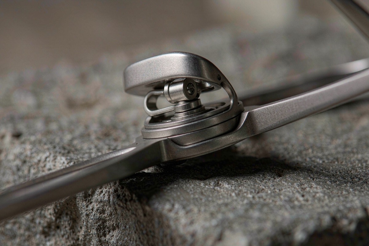 Close-up of eyeglass hinges resting on a dark surface