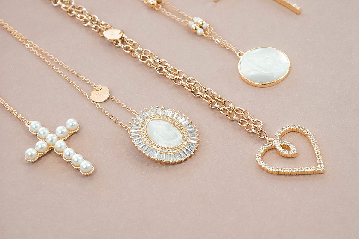 Gold chains laid out on a neutral surface