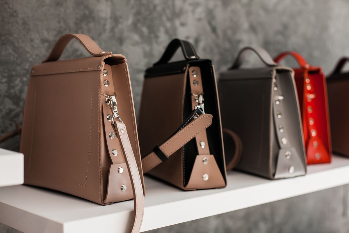 Tan leather tote bag standing upright