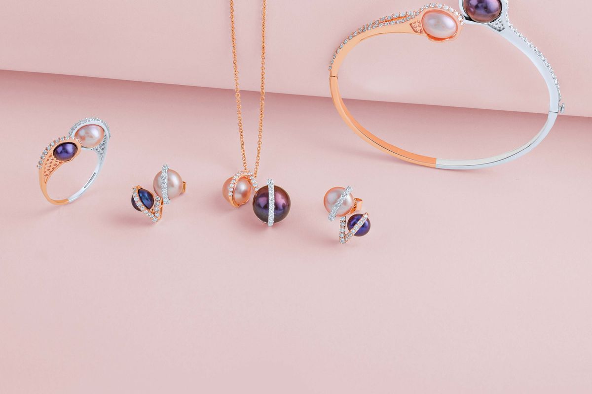 A single string of white pearls laid out in soft light