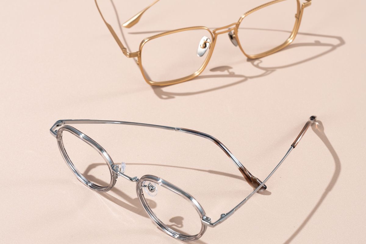 Reading glasses held above a page of small printed text