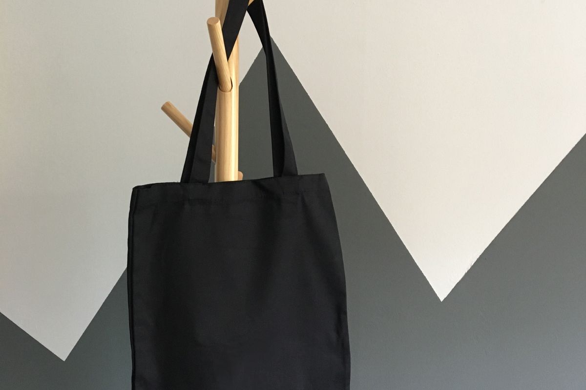 Canvas tote bag hanging on a wooden chair
