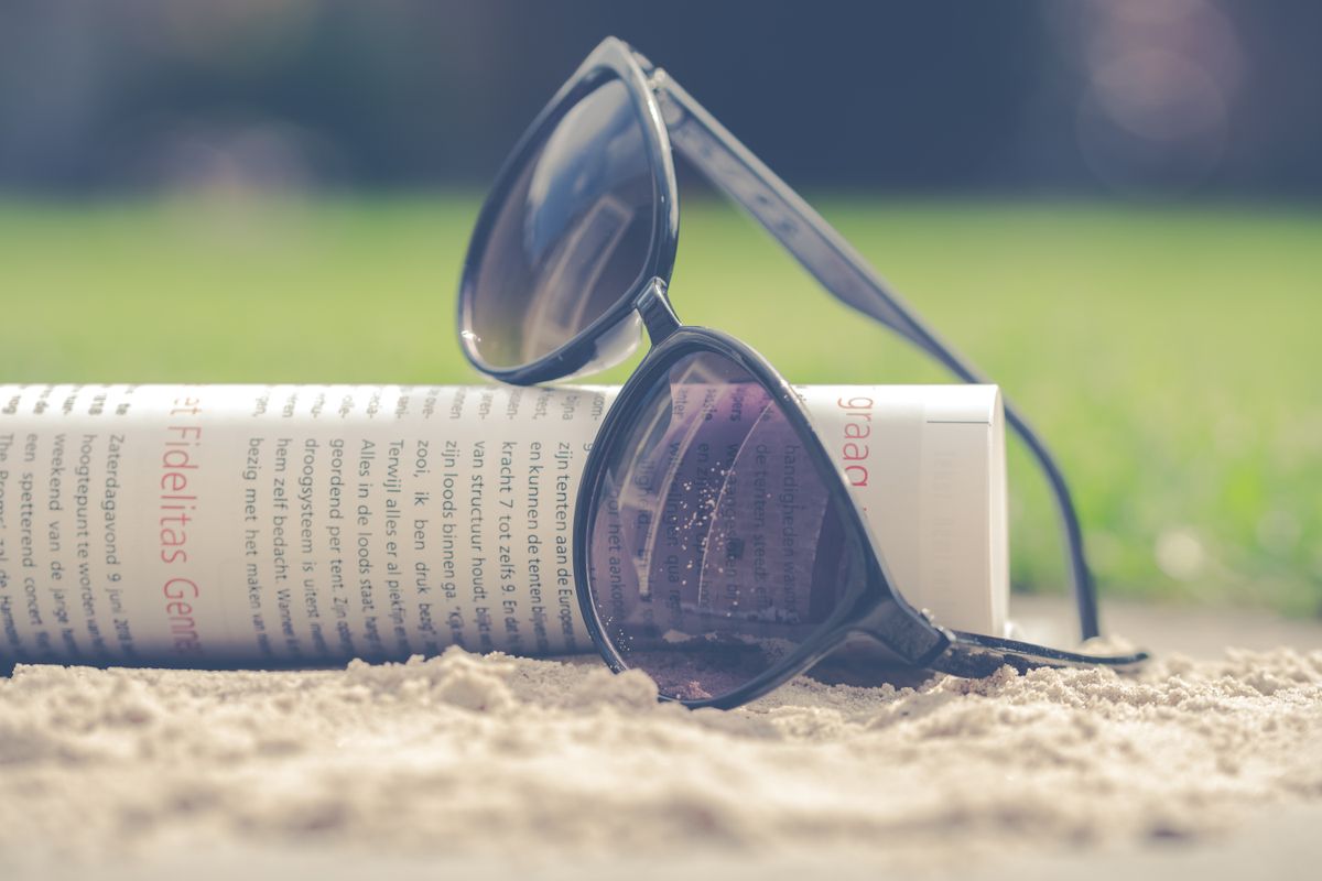 Dark sunglasses resting on a sunlit table